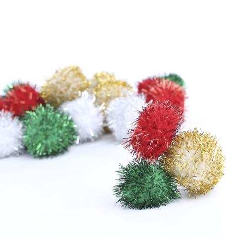 Image of green, gold, white, and red metallic pom poms.