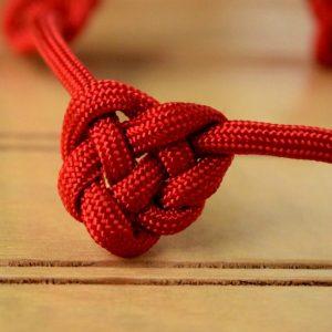 Image of a red Celtic heart knot made from paracord.