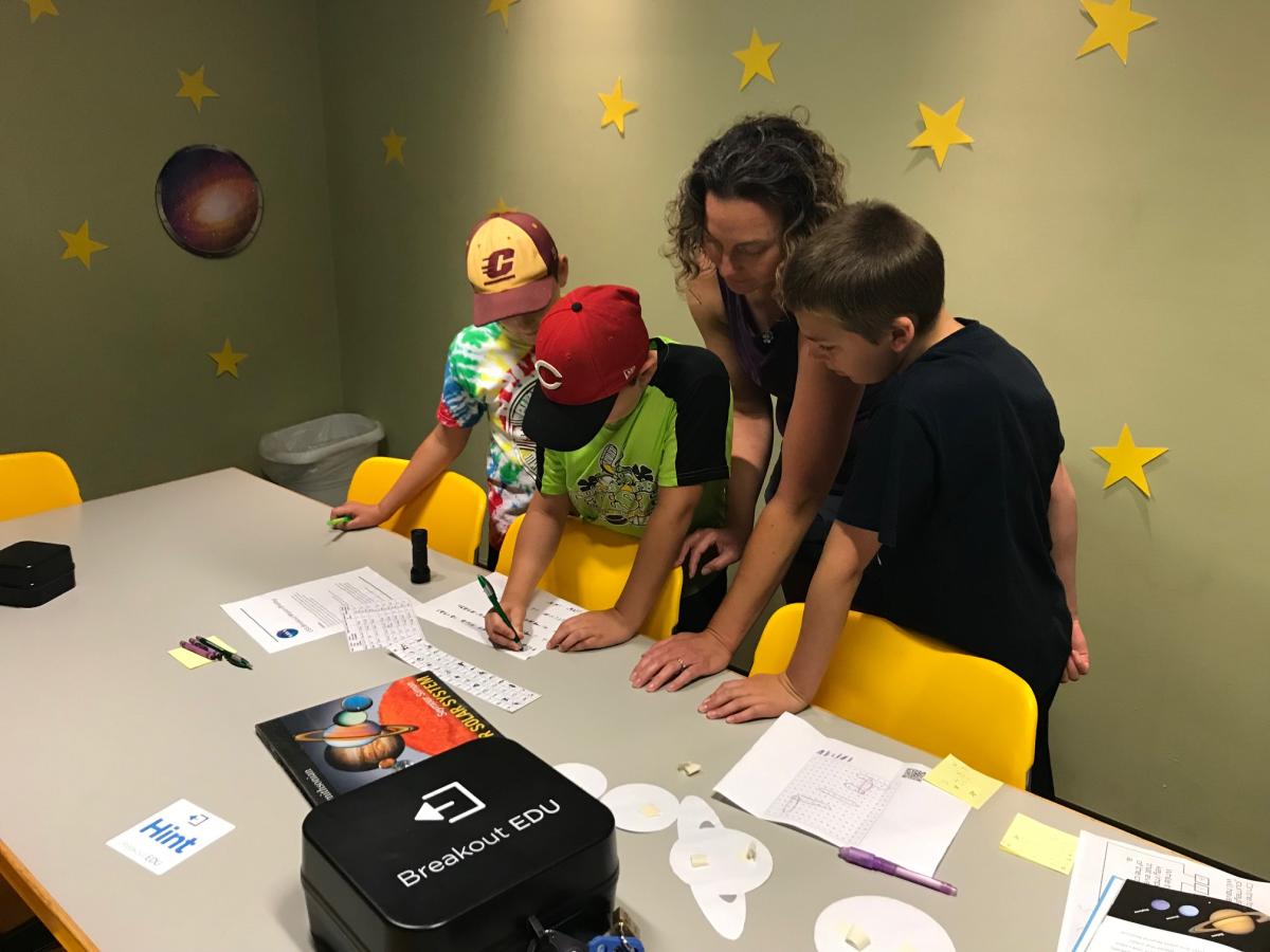 Image of a family playing a breakout game