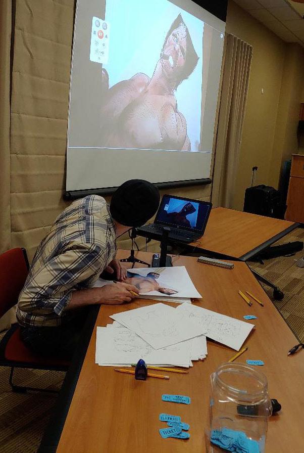 Image of a man teaching a comic book workshop