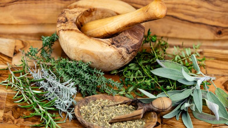 Image of a mortar and pestle with dried herbs.